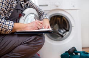 Repairman repairing a washing machine